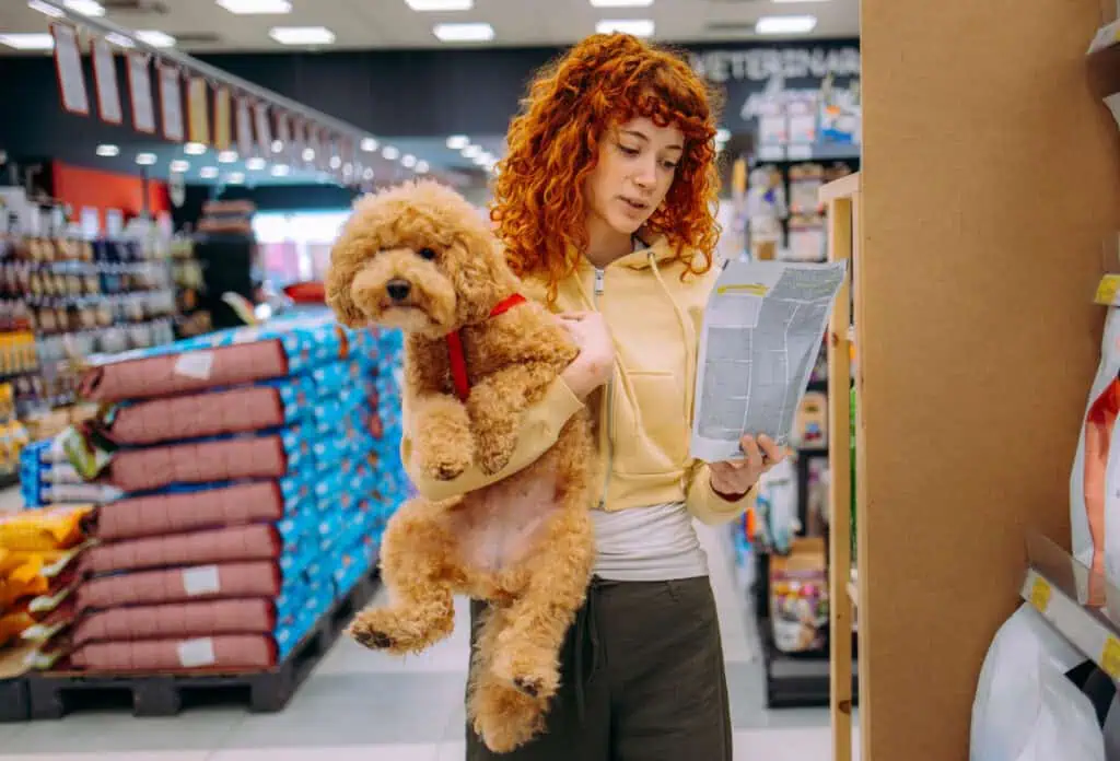 Women in a pet shop, having fun with her dog